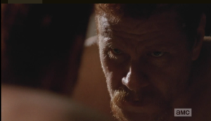 Abraham's face is grim as he peers at his reflection in the mirror.