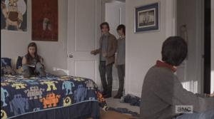 In Rowan's room, two teens, a boy and a girl, are hanging out. Rowan introduces Carl to