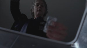 Before going into the armory, Carol opens the freezer and helps herself to another bar of chocolate...Carol, Carol, Carol, Olivia may not notice a few missing handguns, but I have a feeling she sure as hell will notice missing bars of chocolate!