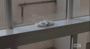 As everyone files out of the storeroom, we see that Carol has opened the window's latch.