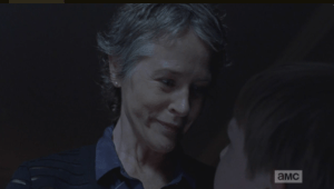 Creepy Carol smiles at the child before her, who is shaking with fright.