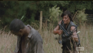 Daryl spears a walker's head and rushes in. Aaron follows suit...