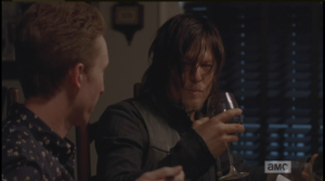 Daryl listens politely, drinking his wine, looking blankly at Eric. It is clear that what Eric is saying doesn't register, and Eric looks questioningly at Aaron, who looks back at him significantly.