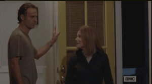 Deanna looks at Rick, smiling.