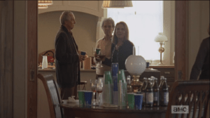 It is truly surreal to see people holding glasses of wine, milling and mingling, a table stocked with assorted beverages and brightly colored plastic party cups. Deanna spies them across the room, and, delighted, makes her way across the party to greet them.