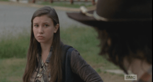 Carl looks over at Enid, who is watching him. They regard each other for a moment, and then Carl asks her,
