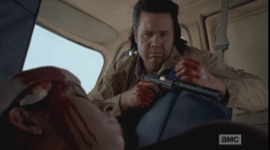 Holding the gun, in case Nicholas wakes up, Eugene first looks towards Nicholas, then at Tara...