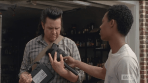 Eugene reluctantly takes the gun, looks down at it with dismay.