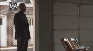 We see Father Gabriel step into a garage that has been converted into a church. 