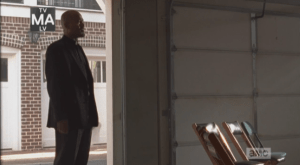 We see Father Gabriel step into a garage that has been converted into a church.