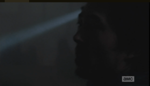 As Glenn calls for the others, we see the shadowy figures of the walkers in the background, coming closer.