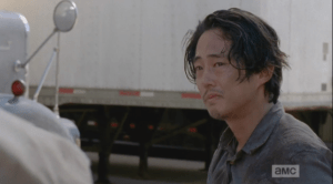 Glenn looks at Eugene, too distraught to answer. His look, and his red, swollen eyes say it all. He walks away.