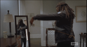 Michonne pulls out the katana and customizes one of the laces that is too long to be functional.