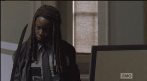 Michonne looks at the katana...she seems to be wondering,