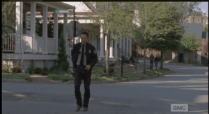 We see Rick walking past