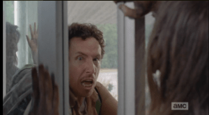 Nicholas is having a hard time holding his side of the door steady, and panicked, yells for Glenn to stop, that it's not safe...
