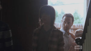And then, it's party time. Carol, Carl, and Rick, holding Judith, file into Deanna's home.