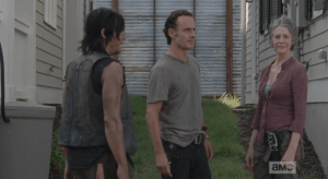 As Carol grins benignly at a curious passerby, Rick and Daryl try to look casual...just a neighborly yard chat, here. Looking away, Rick informs them that they will all be sleeping in the same house tonight.