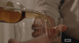 Reg graciously offers Rick a drink, and Rick, after a moment's hesitation, and some good ol' fashioned peer pressure from Reg, accepts. The men clink glasses and drink...