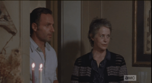 Meanwhile, Rick and Carol try to act natural at the party. They watch Olivia arrive, and that means the storeroom and armory are unguarded at the moment. Rick once again offers to back Carol up, but once again, she tells him to stay put...Rick watches her leave, says,