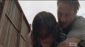 Before Daryl can unleash some pent-up frustration on Nicholas, Rick grabs him from behind, 