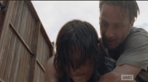 Before Daryl can unleash some pent-up frustration on Nicholas, Rick grabs him from behind,