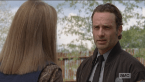 Rick brings Deanna outside, points out that the walls need to be partrolled always, not just checking for damage, but also for any activity or signs that they had been breached. Rick also points out that someone could move right up the supports on the outside of the walls.