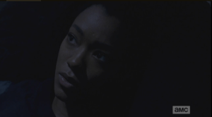 sasha looks away into dark