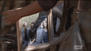 We see Sasha begin to set up the framed pictures, one by one.