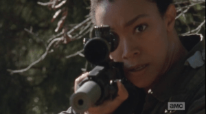 Sasha's eyes are wild, and her manner is looking more and more agitated as she raises her rifle again, and begins picking off all the framed pictures, one by one. Each shot is perfectly aimed, not a bullet wasted...