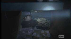 Glenn asks if she is breathing...Eugene replies that he doesn't know, he can't tell from where he is...then Eugene starts saying, over and over, with growing alarm,