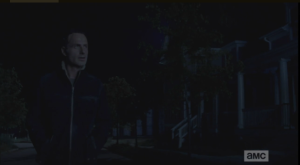 As Rick walks down the darkened, empty streets, a voice carries to him from one of the front porches. 