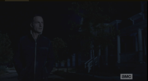 As Rick walks down the darkened, empty streets, a voice carries to him from one of the front porches.