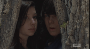 Carl and Enid turn to watch the last of the walkers pass...