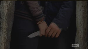 ...and Carl touches Enid's hand, holding her mother's knife, briefly with his own.