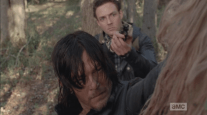 Aaron raises his gun as the young woman walker begins to snarl and bare her teeth.