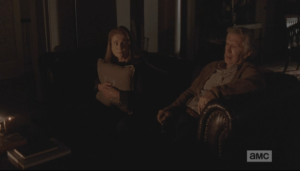 As Spencer kills the music, Deanna hugs a throw pillow miserably to her chest. A knock on the door surprises them.