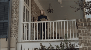 Deanna looks up from her papers and watches Rick pass, with some alarm showing on her face.