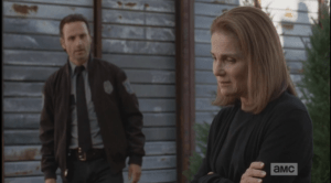 Deanna looks down regretfully, says,