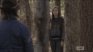 Enid emerges from behind a tree. 