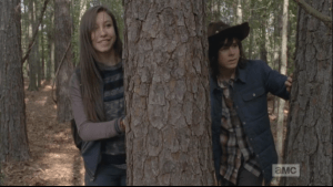 ...Enid smiles a moment before turning and running off, Carl in hot pursuit.