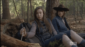Enid reaches into her pack, pulls out a fine knife with a wooden handle, and begins carving into the stump.