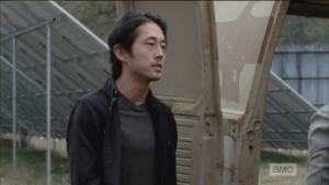 Glenn approaches, comes around the van, addresses Nicholas, who is inside.