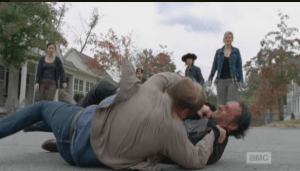 ...but the large man gains the advantage, and ends up on top of Rick.