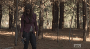 Michonne then looks down at the gun she is holding...she seems to be thinking about what the gun represents: the Alexandria way, and her new position as constable. Is their