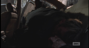 In the next shot, we see Morgan carefully lay the unconscious blond man on top of his dark haired counterpart in the back seat of the abandoned car he had spent the previous night in. Enjoy your nap, douchebags, and btw, those 