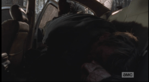 In the next shot, we see Morgan carefully lay the unconscious blond man on top of his dark haired counterpart in the back seat of the abandoned car he had spent the previous night in. Enjoy your nap, douchebags, and btw, those