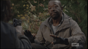 Morgan turns back towards the young man, his hands raised in a gesture of surrender.