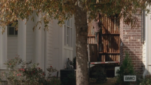 ...Nicholas, climbing up, and over, the fence. Glenn stands, looks around, then sets off after Nicholas.