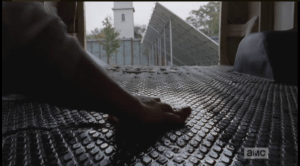 We see a hand scrubbing out the blood in the back of the run van...